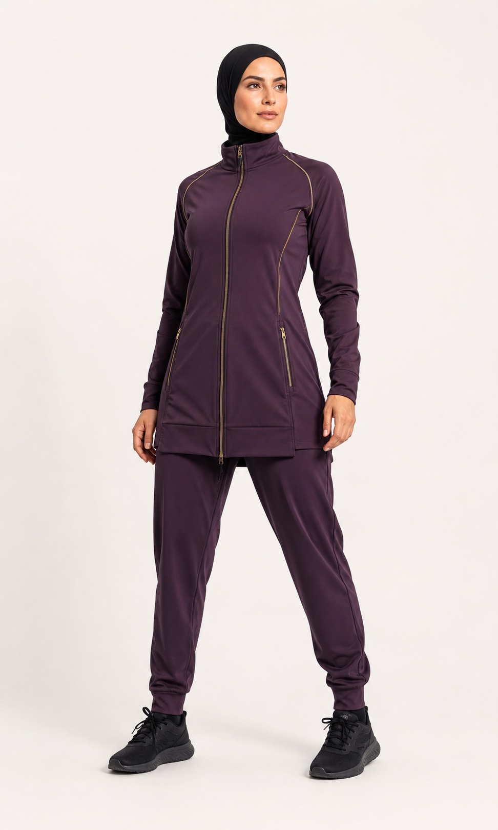 Athlete wearing a purple longline jacket and jogger performance set